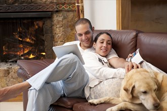 Hispanic couple relaxing on sofa together