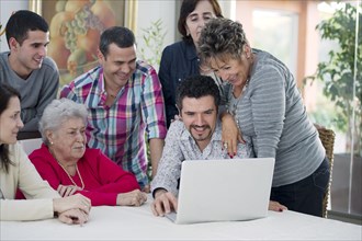 Hispanic family looking at laptop