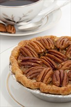 Small pecan pie and cup of coffee