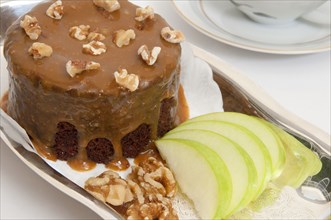 Small chocolate cake and sliced apples