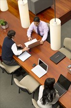 Hispanic businessmen having meeting in conference room