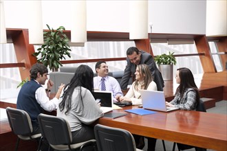 Hispanic business people having meeting in conference room