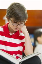 Hispanic boy reading book