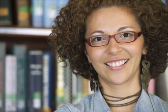 Smiling Hispanic woman in library