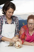 Hispanic mother and daughter baking together