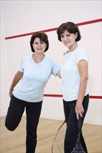 Senior Hispanic twins preparing to play squash