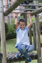 Hispanic boy playing at playground