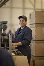 Hispanic woman working in bottling factory