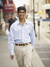 Indian man walking in urban setting