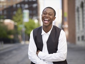 African man laughing in urban setting