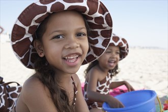 Young mixed race girls playing at beach