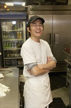 Japanese chef smiling with arms crossed