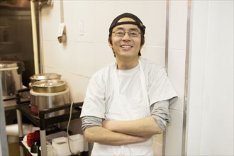Japanese chef smiling in commercial kitchen