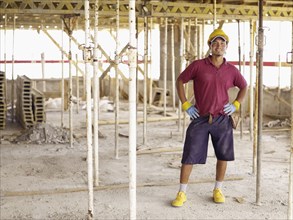 Hispanic worker standing on construction site
