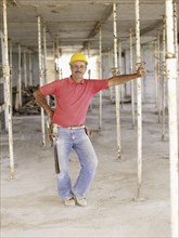 Hispanic worker standing on construction site