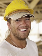 Hispanic worker smiling on construction site