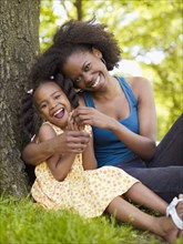 African mother and daughter hugging in park