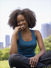 African woman smiling in park