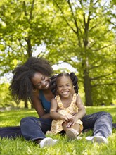 African mother and daughter hugging in park