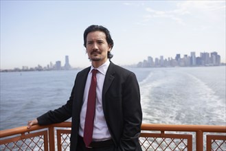 Mixed race businessman on ferry