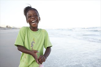 Laughing Jamaican girl on beach