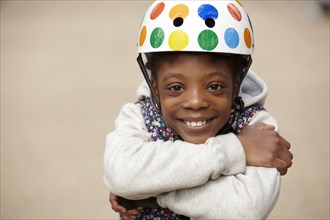 Smiling mixed race girl in helmet