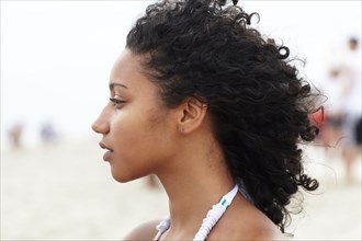 Serious mixed race woman on beach