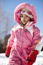 Mixed race girl wearing snowsuit