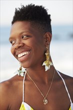African American woman smiling on beach