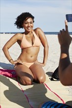 Woman posing for photograph on beach