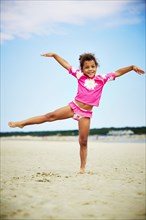 Mixed race girl posing on beach