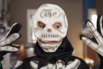 Black boy wearing skeleton Halloween costume