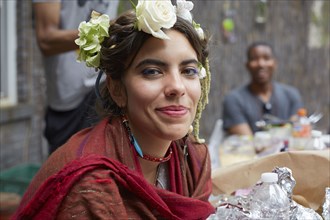 Close up of smiling woman wearing flowers and shawl