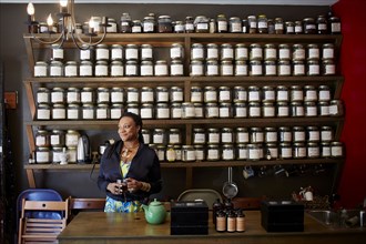 Black woman drinking tea in tea shop