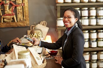 Black woman purchasing tea in tea shop