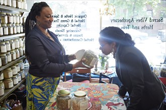 Black woman smelling tea in tea shop