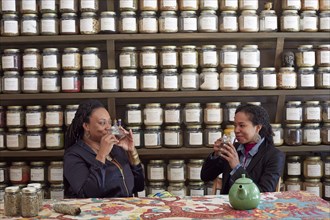 Black women drinking tea in tea shop