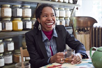 Black woman drinking tea in tea shop