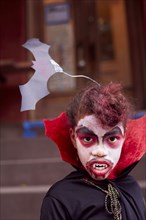 Mixed race girl wearing vampire costume
