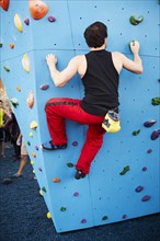 Caucasian man climbing outdoor climbing wall