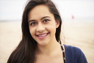 Mixed Race woman smiling on beach