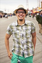 Hispanic man smiling on boardwalk