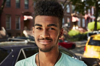 Portrait of smiling Black man in city