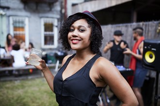 Portrait of smiling Mixed Race woman at backyard party