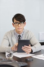 Korean businessman using digital tablet in office