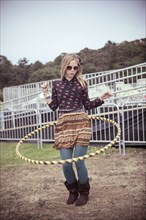 Woman playing with hula hoop at festival