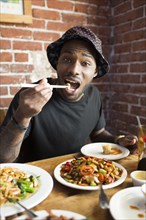 African American man eating at restaurant