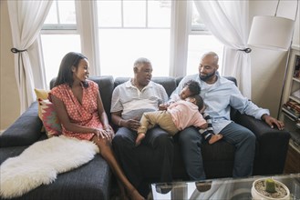 African American family relaxing on sofa
