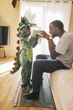 African American father playing with daughter in costume