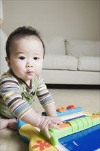Asian baby playing on the floor